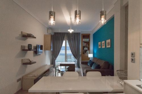 a living room with a couch and a table at Luxury Apartment Philoxenia in Thessaloniki