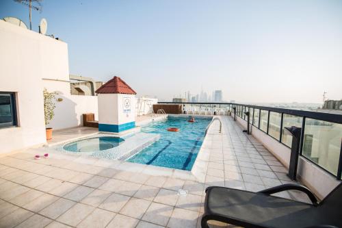 a swimming pool on the roof of a building at Welcome Hotel Apartments 1 in Dubai