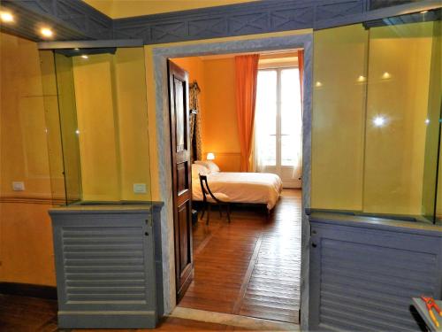 a room with a bedroom with a bed and a window at Bigo Guest House in Genova