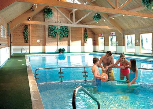 a group of people standing in a swimming pool at Barmouth Bay Holiday Park in Barmouth
