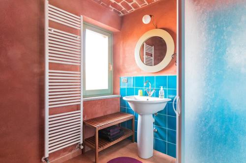 a bathroom with a sink and a mirror at La casetta di Lu in Cellarengo