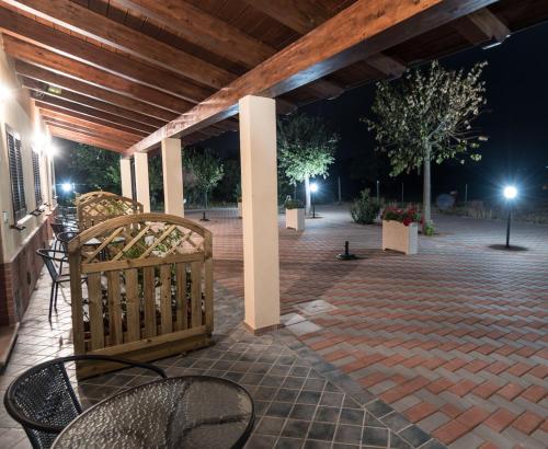 an outdoor patio at night with chairs and tables at Il Rifugio di San Francesco in Bastia Umbra