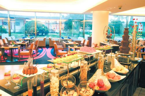 a buffet line with food on display in a restaurant at Beijing Landmark Towers in Beijing