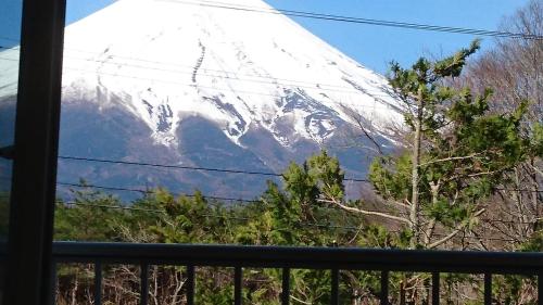 a snow covered mountain viewed from a window at Inn Yamanami in Yamanakako