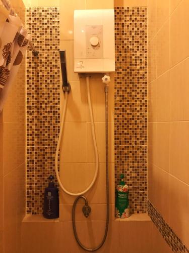 a shower in a bathroom with a shower at Tiger Cave Home in Krabi