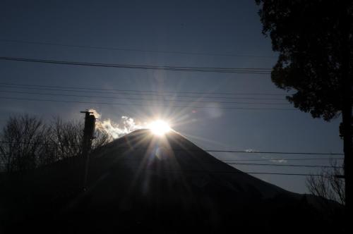 a sun is shining on top of a hill at Inn Yamanami in Yamanakako
