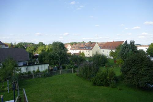 a view of a yard with houses and trees at Fewo Am Messepark in Löbau