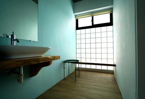 a bathroom with a sink and a large window at The Red Hotel in Nanwan