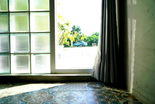 an open door in a room with a tile floor at The Red Hotel in Nanwan