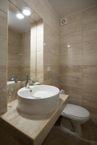 a bathroom with a white sink and a toilet at Apartments Grand in Sveti Stefan