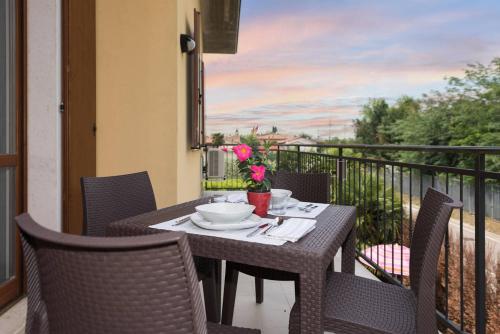 a table and chairs on a balcony with a view at Dimora Ronchi in Ronchi