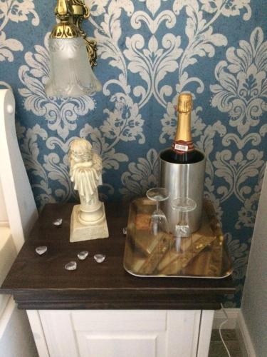a table with a bottle of champagne and a blender at Pension Schmitz in Serrig