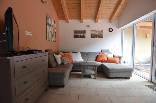 a living room with a couch and a tv at Villa 22 in Oetz