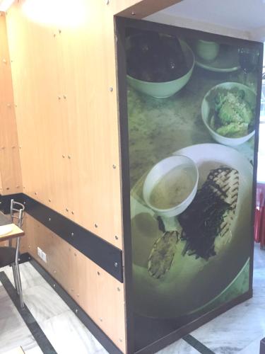 a cabinet with a picture of a turtle in it at Angel Residency in Greater Noida