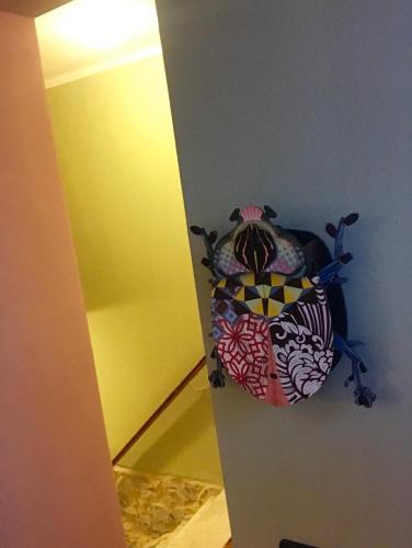 a room with a pillow on a wall next to a mirror at Charming Rooms Opuntia in Carloforte