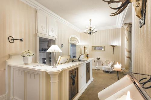 a room with a counter with a desk in it at Burghotel Haselünne in Haselünne
