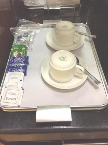 a tray with two cups and plates on it at Angel Residency in Greater Noida