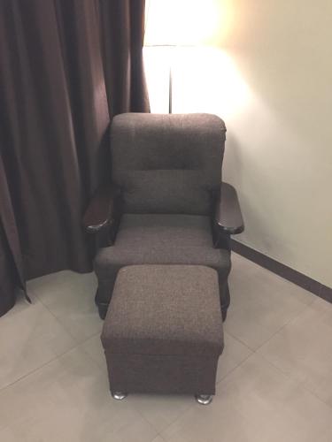 two chairs and a ottoman in a room at Angel Residency in Greater Noida