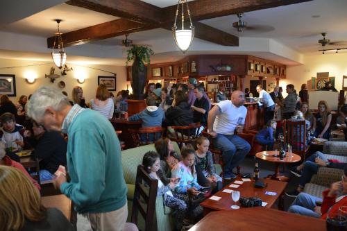 a crowd of people sitting in a restaurant at Gooderson Drakensberg Gardens Golf & Spa Resort in Drakensberg Garden
