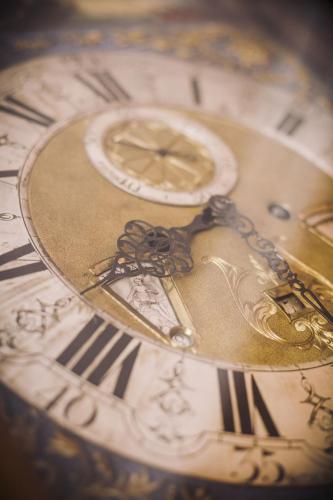 a close up of a gold and white clock at Burghotel Haselünne in Haselünne