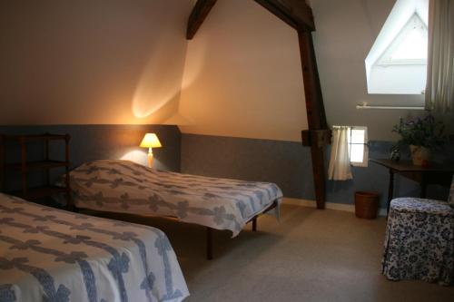 Giường trong phòng chung tại Le Loft du Grand Saulaie