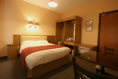 a hotel room with a large bed in it at The Parkway Hotel in Dunmanway