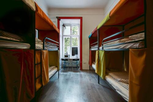 a room with several bunk beds and a desk at Pal's Mini Hostel in Budapest