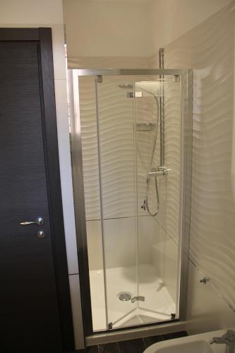 a glass shower in a bathroom with a toilet at B&B Villa Mirella in Bordighera