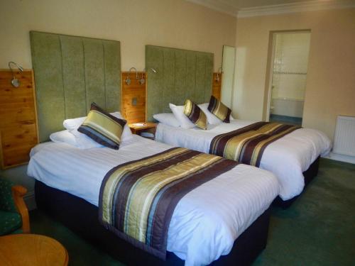 a hotel room with two beds in a room at Burton Hotel in Kington