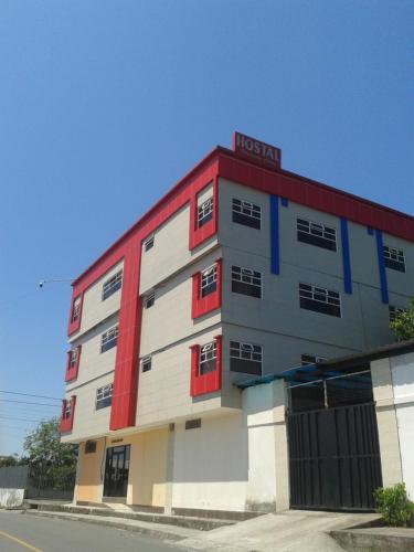 a hotel building with red and white at Hotel Platinum Class in Nueva Loja