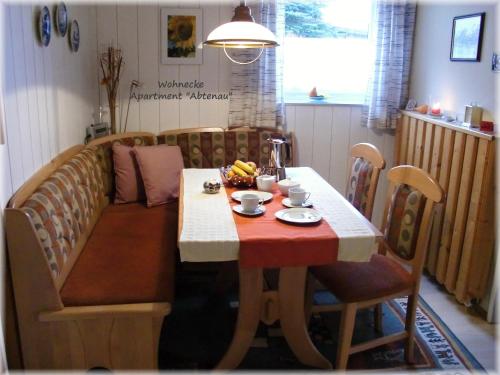 a dining room table with a red and white table cloth at Apartment Dreier - Salzburger Land in Abtenau