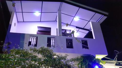 a white building with lights on top of it at Green Garden Guest Mirissa in Mirissa