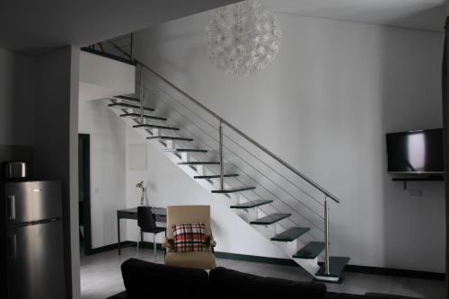 a staircase in a living room with a couch at DoBairro suites at Bairro Alto in Lisbon