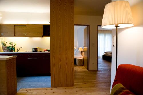 a kitchen and a living room with a table at Residence Gustav Thoeni in Prato allo Stelvio