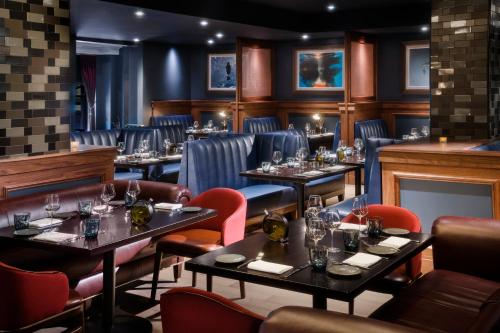 a restaurant with tables and chairs in a room at The Darcy Hotel, Washington DC in Washington