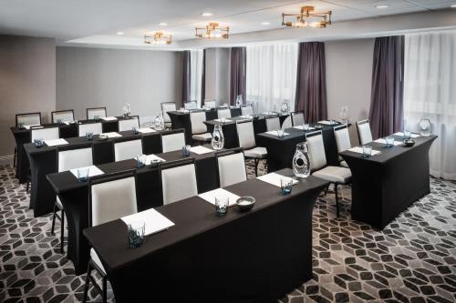 a room filled with tables and chairs with wine glasses at The Darcy Hotel, Washington DC in Washington