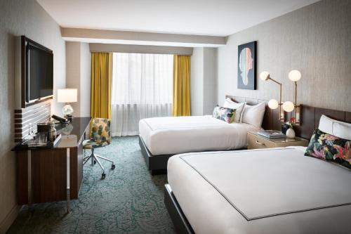 a hotel room with two beds and a desk at The Darcy Hotel, Washington DC in Washington