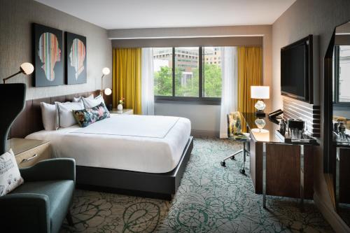 a hotel room with a large bed and a television at The Darcy Hotel, Washington DC in Washington