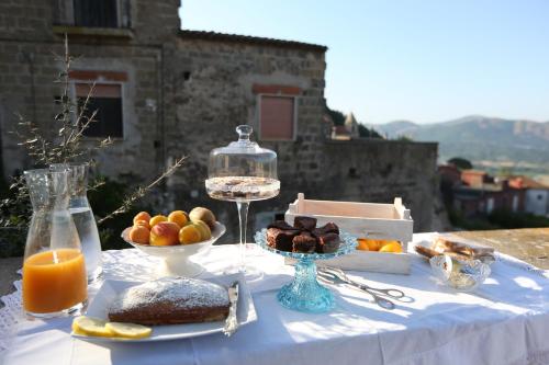 a table with a plate of food and a glass of orange juice at Casa Aulivo in Caiazzo