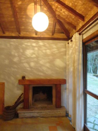 a living room with a fireplace in a house at Estalagem Engenho de Serra - Parque Nacional do Itatiaia - Parte Alta in Itamonte