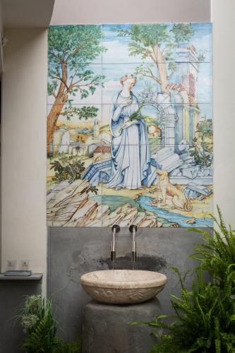 a mural of a woman and a sink in a bathroom at Hotel Delle Terme Santa Agnese in Bagno di Romagna