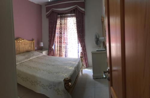 a bedroom with a bed in front of a window at Ix Xaluppa J6 Apartment in Għajnsielem