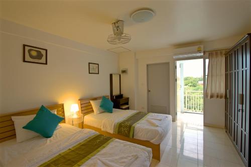 A bed or beds in a room at Charn Residence