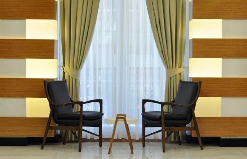 two black chairs sitting in front of a window at Double Comfort Hotel in Ankara