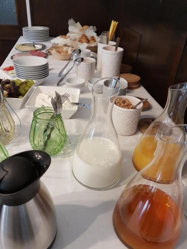 a table with two glass vases of milk on it at Olivin Kytlice in Kytlice