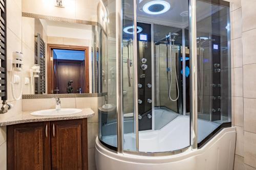 a bathroom with a shower and a sink at Hotel *** Rancho Lot in Nowy Targ