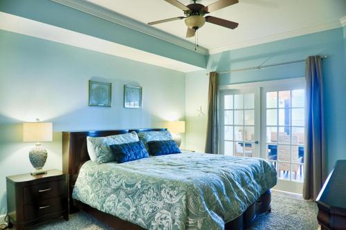 a bedroom with a bed and a ceiling fan at Phoenix West II Unit 1109 in Orange Beach