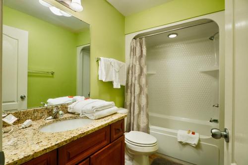 a bathroom with a sink and a toilet and a shower at Phoenix West II Unit 1109 in Orange Beach