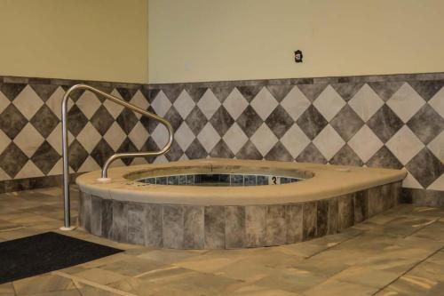 a large bath tub in a room with a tile wall at Phoenix West II Unit 1109 in Orange Beach