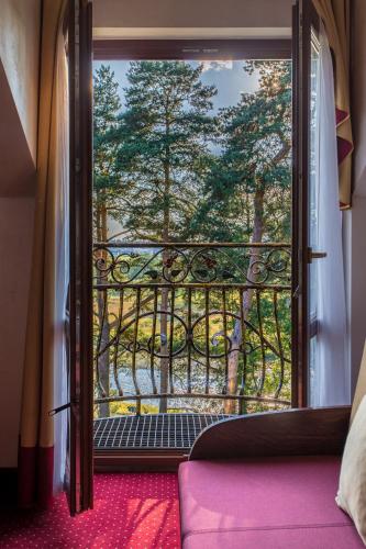 an open door to a balcony with a view of trees at Hotel *** Rancho Lot in Nowy Targ